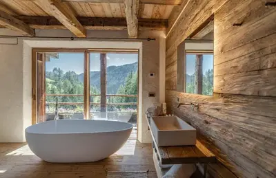 a large bathroom with a large tub and a window at Chalet Dolomites Luxe con Spa, Piscine, Jacuzzi e Cinema Privato in Livinallongo del Col di Lana