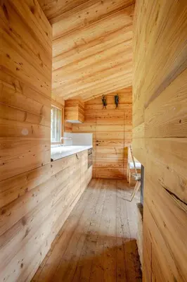 a sauna with wooden walls and wooden flooring at Chalet Dolomites Luxe con Spa, Piscine, Jacuzzi e Cinema Privato in Livinallongo del Col di Lana