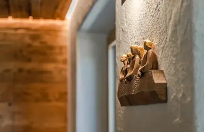 a wooden object on the side of a wall at Chalet Dolomites Luxe con Spa, Piscine, Jacuzzi e Cinema Privato in Livinallongo del Col di Lana