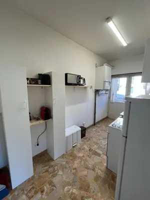 a small kitchen with white cabinets and a microwave at Appartamento 135mq - Splendida Vista Sul Lagorai in Cavalese