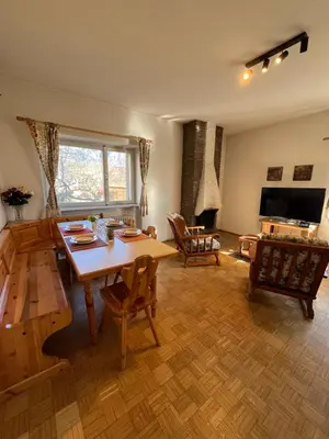 a living room with a wooden table and chairs at Appartamento 135mq - Splendida Vista Sul Lagorai in Cavalese
