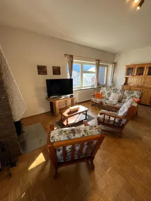 a living room with a couch and a tv at Appartamento 135mq - Splendida Vista Sul Lagorai in Cavalese