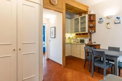 a kitchen and dining room with a table and chairs at Dimora al Penegal, Passo Mendola Ospitar in Mendola