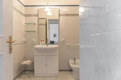 a bathroom with a sink and a toilet and a mirror at Dimora al Penegal, Passo Mendola Ospitar in Mendola