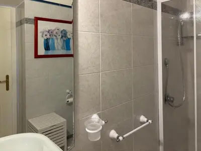a bathroom with a shower with a glass door at Dimora al Penegal, Passo Mendola Ospitar in Mendola