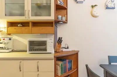 a kitchen with a counter with a laptop on it at Dimora al Penegal, Passo Mendola Ospitar in Mendola