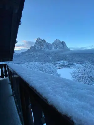 a snow covered balcony with a view of a mountain at Kreuzerhof in Siusi