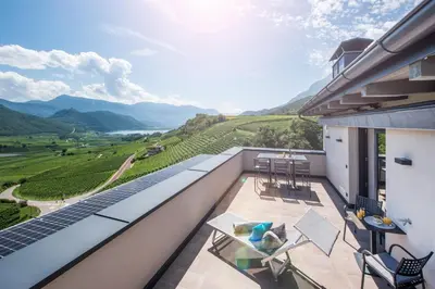 a balcony with a view of a vineyard and mountains at Villa Barleit in Caldaro