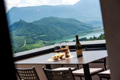 a table with two glasses of wine and a view at Villa Barleit in Caldaro