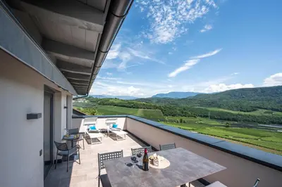 a balcony with a table and chairs and a view at Villa Barleit in Caldaro