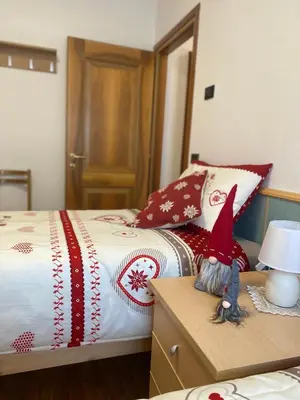 a bedroom with a bed with a bed sidx sidx sidx at Appartamento Madama in Falcade