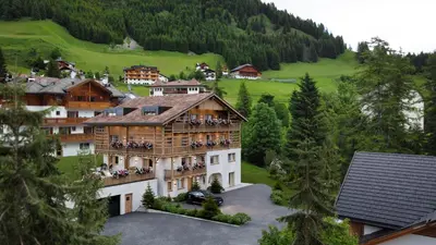 a building with people sitting on the balconies of it at Residence Odlina in Colfosco