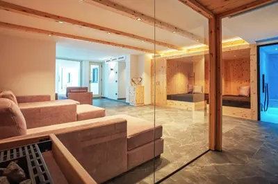 a living room with a couch and a bedroom at Residence Odlina in Colfosco