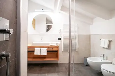 a bathroom with a sink and a mirror at Residence Odlina in Colfosco