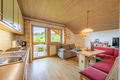 a kitchen and living room with a couch and a table at Gfillhof Ferienwohnung 3 in Eppan an der Weinstrasse ST. Pauls