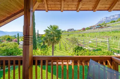 a porch with a view of a green field at Gfillhof Ferienwohnung 3 in Eppan an der Weinstrasse ST. Pauls