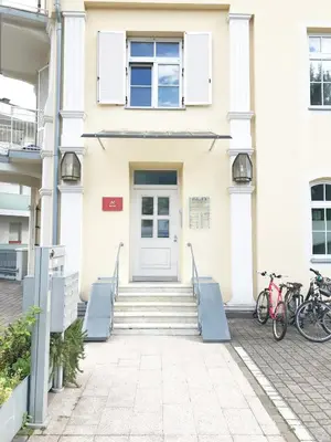 a white house with bikes parked outside of it at Manzoni Rooms in Merano