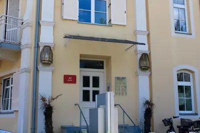 a building with a refrigerator in front of it at Manzoni Rooms in Merano