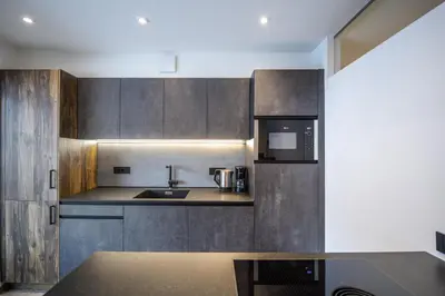 a kitchen with a sink and a microwave at Apartment Villa Hetty 2 in Ortisei