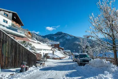 a snow covered street with a car parked on it at Apartment Villa Hetty 2 in Ortisei