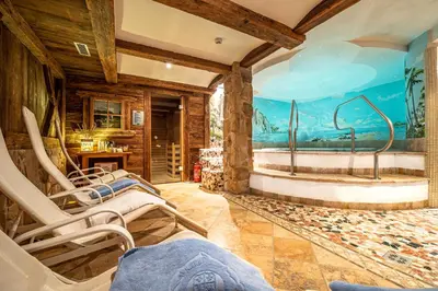 a bedroom with a bed and a sink and a bathroom at De Matie in Canazei