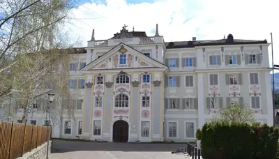 a large white building with a large doorway at Priesterseminar Brixen in Bressanone