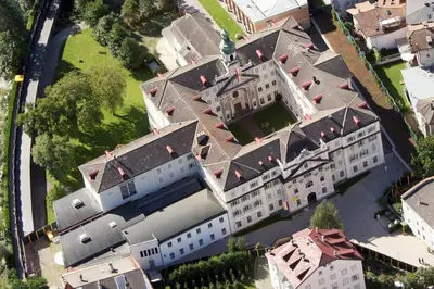 an overhead view of a large white building at Priesterseminar Brixen in Bressanone
