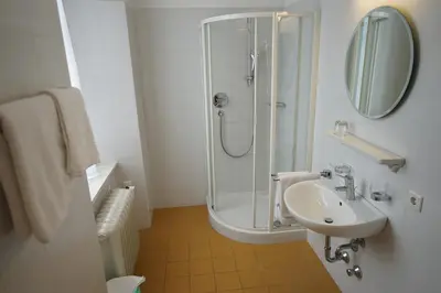 a bathroom with a shower and a sink at Priesterseminar Brixen in Bressanone