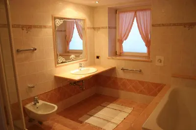 a bathroom with a sink and a toilet and a tub at Freines in La Valle