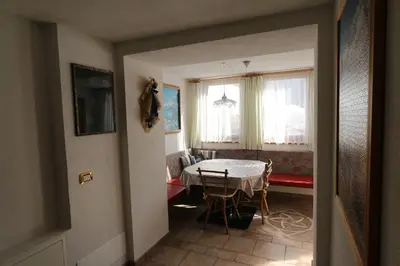 a living room with a table and a table and chairs at Freines in La Valle