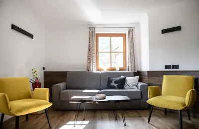 a living room with a couch and two chairs at La Funtana in Santa Cristina in Val Gardena