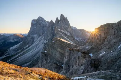 a mountain with the sun setting on it at La Funtana in Santa Cristina in Val Gardena
