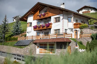 a house on the side of a mountain at La Funtana in Santa Cristina in Val Gardena
