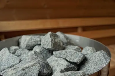a bowl full of rocks sitting on a table at Monte Sole Suite - mit Sauna & Garten in Perca
