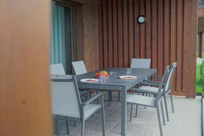 a gray table and chairs on a patio at Monte Sole Suite - mit Sauna & Garten in Perca