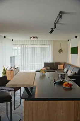 a living room with a couch and a table at Monte Sole Suite - mit Sauna & Garten in Perca
