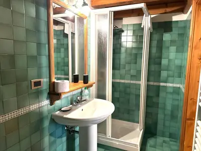 a bathroom with a sink and a shower at Appartamento ampezzano con ampia balconata in San Vito di Cadore