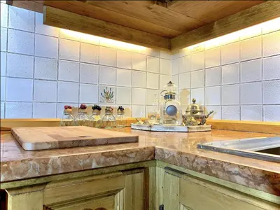 a kitchen with a counter top with a counter top at Appartamento ampezzano con ampia balconata in San Vito di Cadore