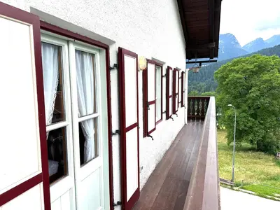 a balcony of a building with a view of the mountains at Appartamento ampezzano con ampia balconata in San Vito di Cadore