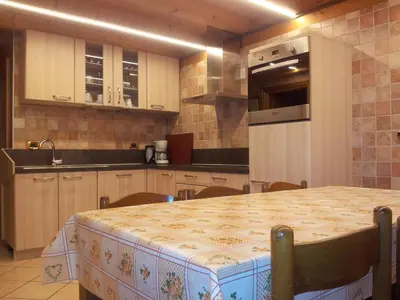 a kitchen with a table and a counter top at Chalet Karin in Arabba