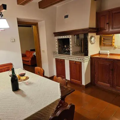 a kitchen with a table with a wine glass on it at Casa Aurine di Zaccaria in Frassenè
