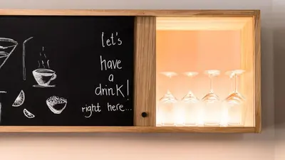 a glass cabinet with a bunch of wine glasses at Flora Hotel & Suites in Merano