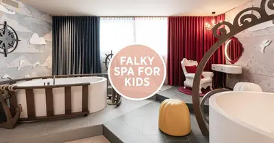 a bathroom with a bath tub and a sink at Falkensteiner Family Resort Lido l 4 Star Superior in Chienes