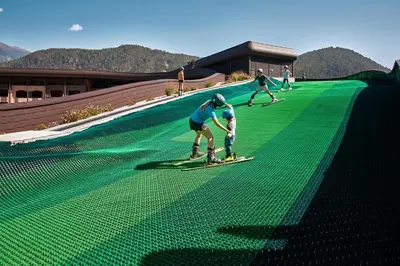 a group of people on skis on a slope at Falkensteiner Family Resort Lido l 4 Star Superior in Chienes
