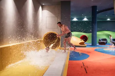 a man is playing in a water park at Falkensteiner Family Resort Lido l 4 Star Superior in Chienes