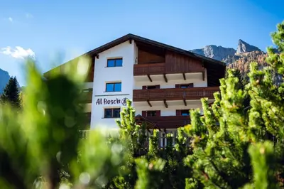 a building with a sign on the side of it at Cèsa Al Bosch in Alba di Canazei