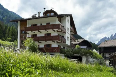a building with a balcony on top of it at Cèsa Al Bosch in Alba di Canazei