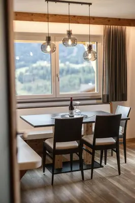 a dining room with a table and chairs and a window at Apartments La Mana in Santa Cristina in Val Gardena