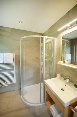 a bathroom with a shower and a sink at Apartments La Mana in Santa Cristina in Val Gardena