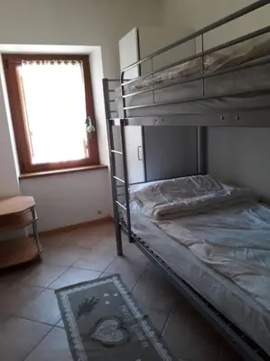 a bedroom with a bunk bed and a window at La cà di nonna Natalia in Brusago